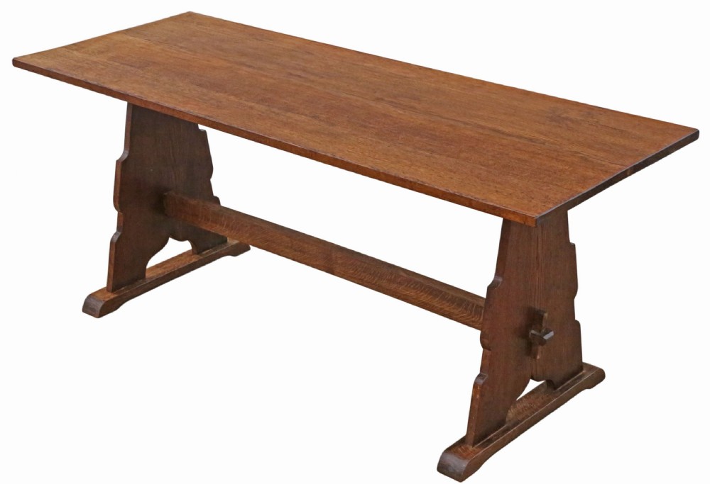 An antique late 19th-century solid oak Arts and Crafts refectory dining table featuring shaped trestle ends and a tusked tenon stretcher. View II