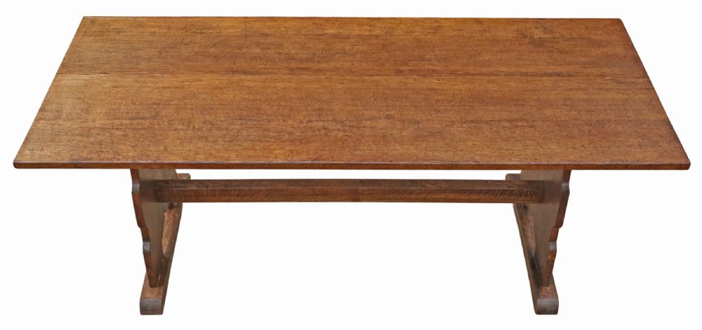 An antique late 19th-century solid oak Arts and Crafts refectory dining table featuring shaped trestle ends and a tusked tenon stretcher. View IV