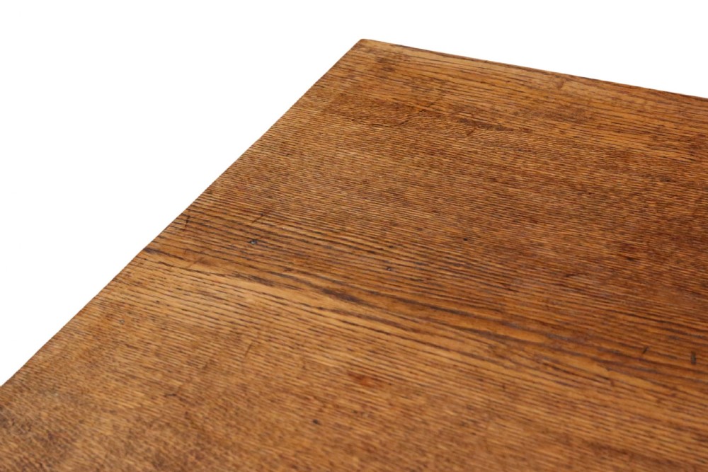An antique late 19th-century solid oak Arts and Crafts refectory dining table featuring shaped trestle ends and a tusked tenon stretcher. View VI