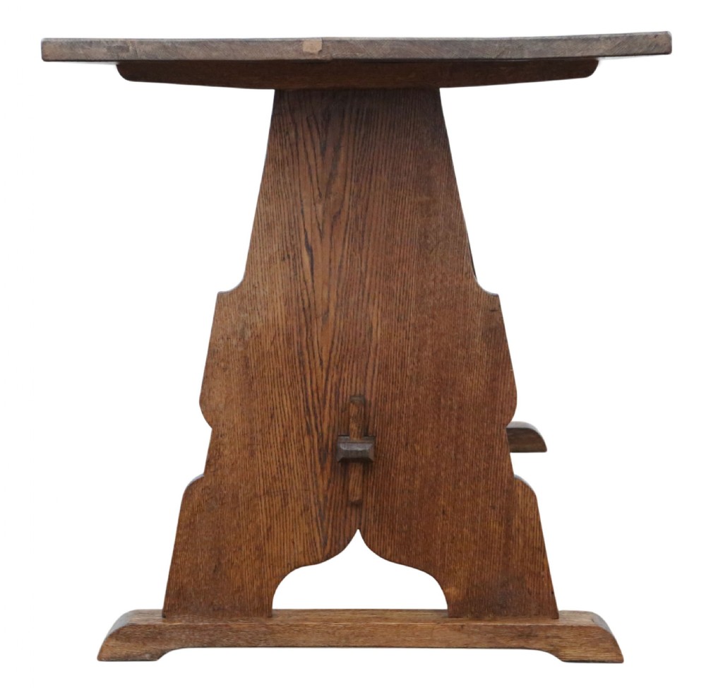 An antique late 19th-century solid oak Arts and Crafts refectory dining table featuring shaped trestle ends and a tusked tenon stretcher. View VII