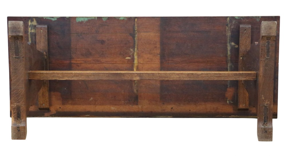 An antique late 19th-century solid oak Arts and Crafts refectory dining table featuring shaped trestle ends and a tusked tenon stretcher. View IX