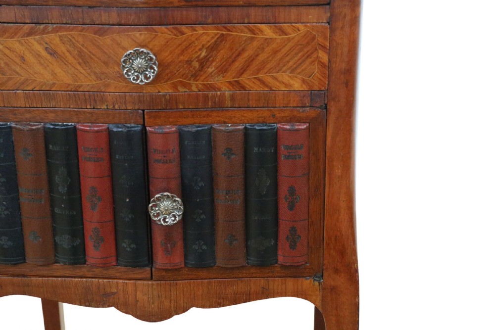 A pair of French parquetry bedside tables featuring slender cabriole legs, a single top drawer, and a lower cabinet concealed by faux leather book spines. View V