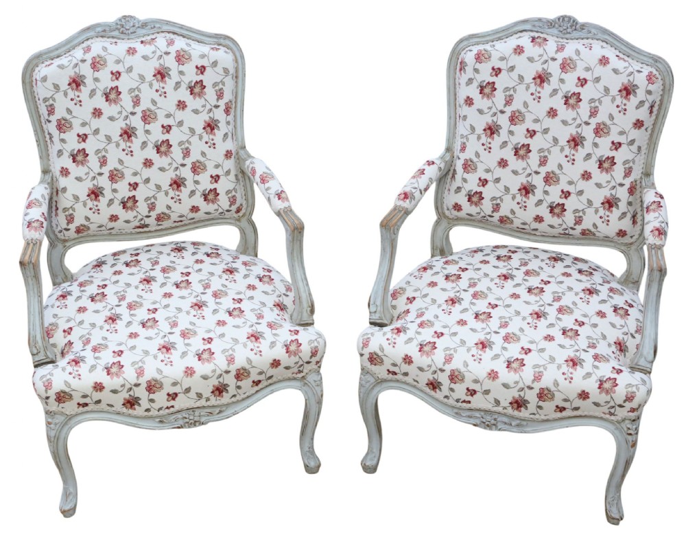 A pair of antique French Louis XV style open armchairs with carved light grey painted frames and floral print upholstery. View II