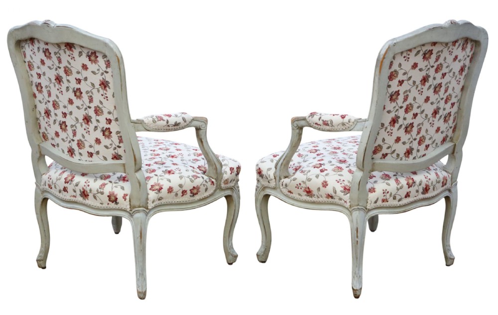 A pair of antique French Louis XV style open armchairs with carved light grey painted frames and floral print upholstery. View IV