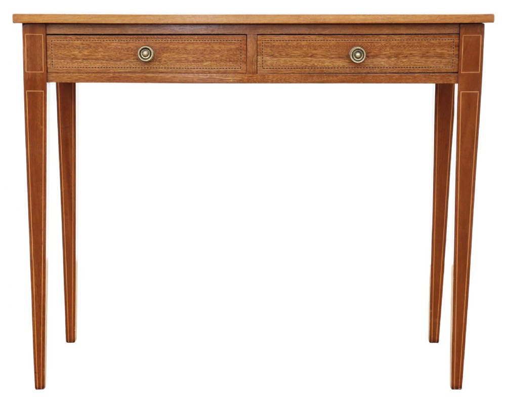An Edwardian red walnut writing table with two drawers, decorative string inlay, brass ring handles, and tapered square legs. View V