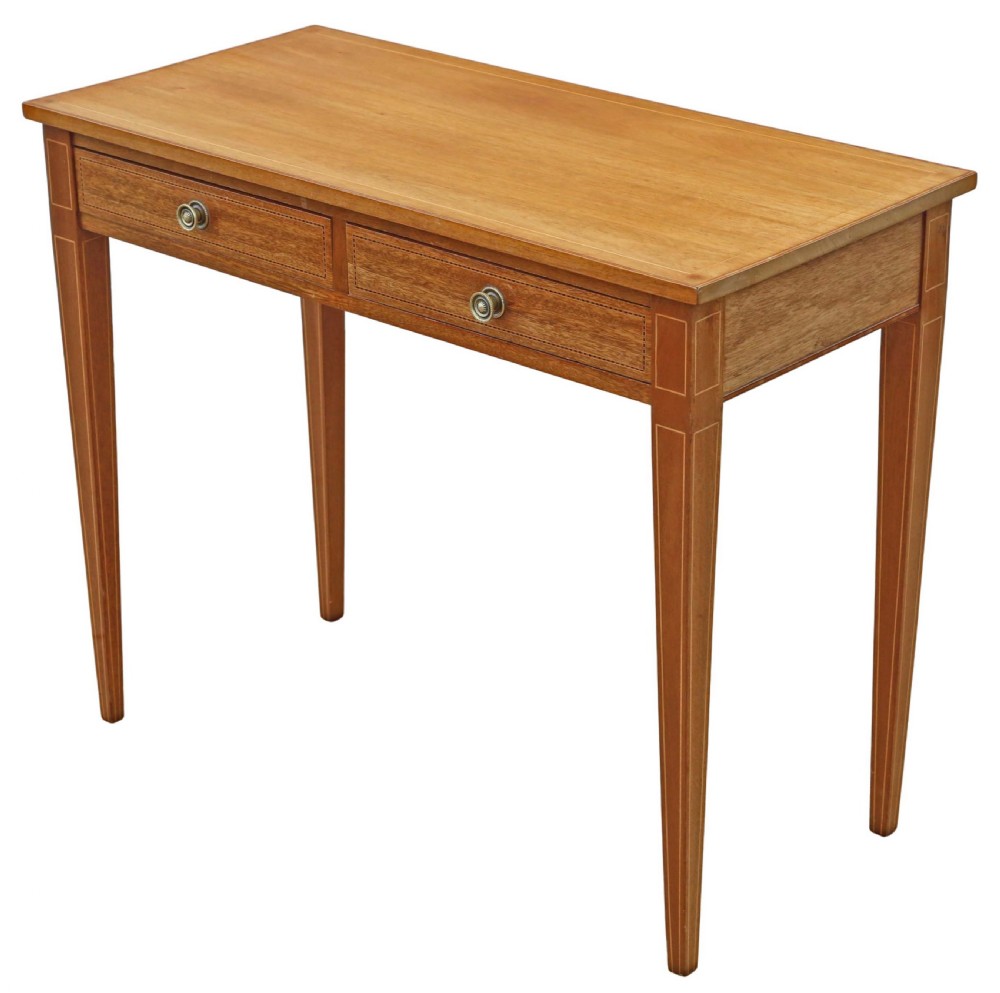 An Edwardian red walnut writing table with two drawers, decorative string inlay, brass ring handles, and tapered square legs. View VI