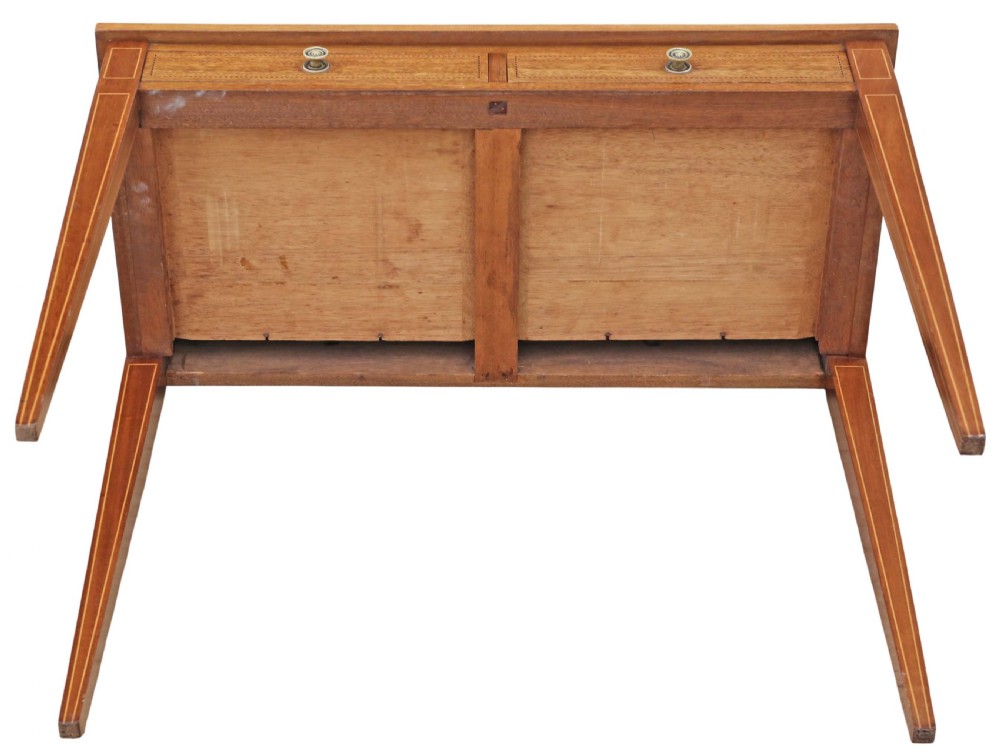 An Edwardian red walnut writing table with two drawers, decorative string inlay, brass ring handles, and tapered square legs. View X