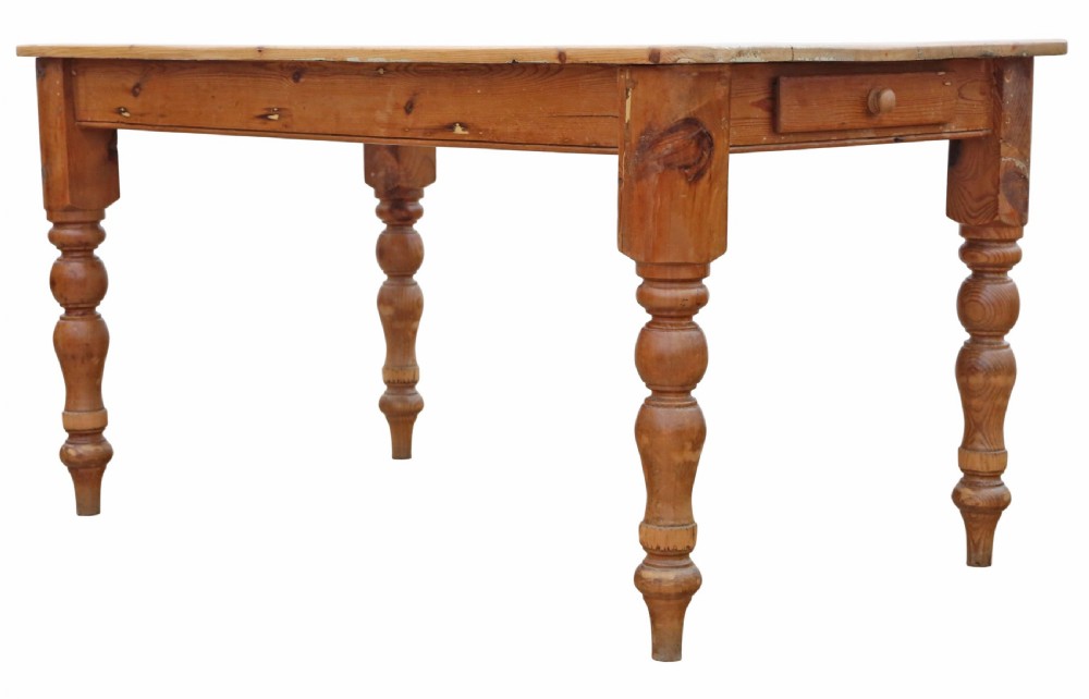 A 19th-century pine kitchen table featuring turned legs, a rectangular plank top, and an end drawer with a turned wood knob. View V