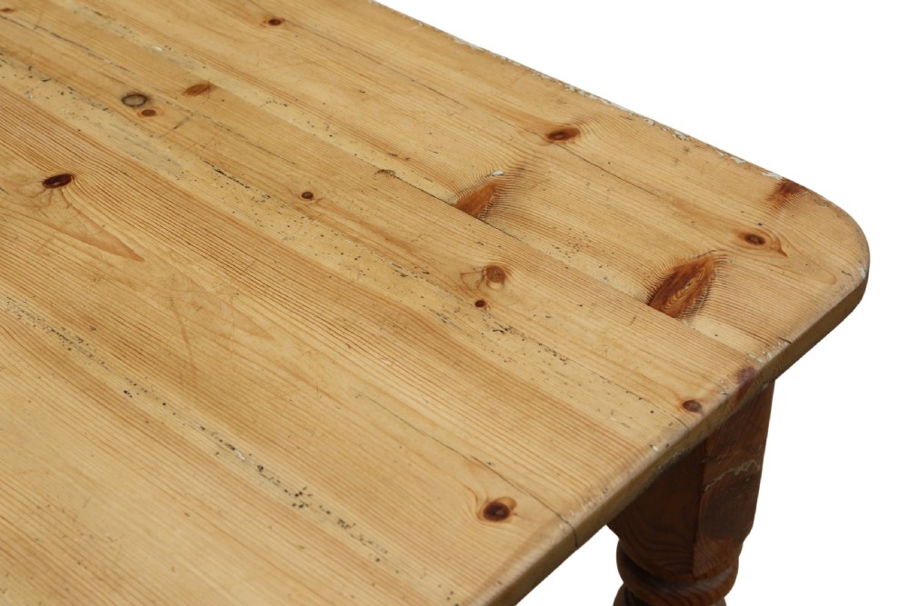 A 19th-century pine kitchen table featuring turned legs, a rectangular plank top, and an end drawer with a turned wood knob. View VI