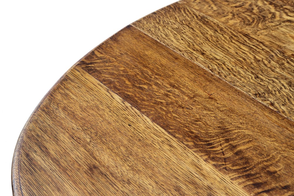 An oval oak drop-leaf dining table with barley twist turned legs and pivoting gateleg supports. View V