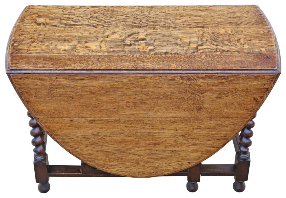 An oval oak drop-leaf dining table with barley twist turned legs and pivoting gateleg supports. View VIII
