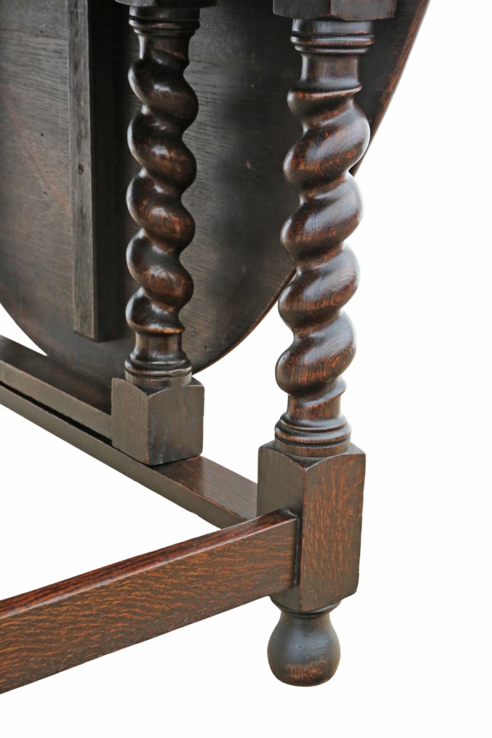 An oval oak drop-leaf dining table with barley twist turned legs and pivoting gateleg supports. View X