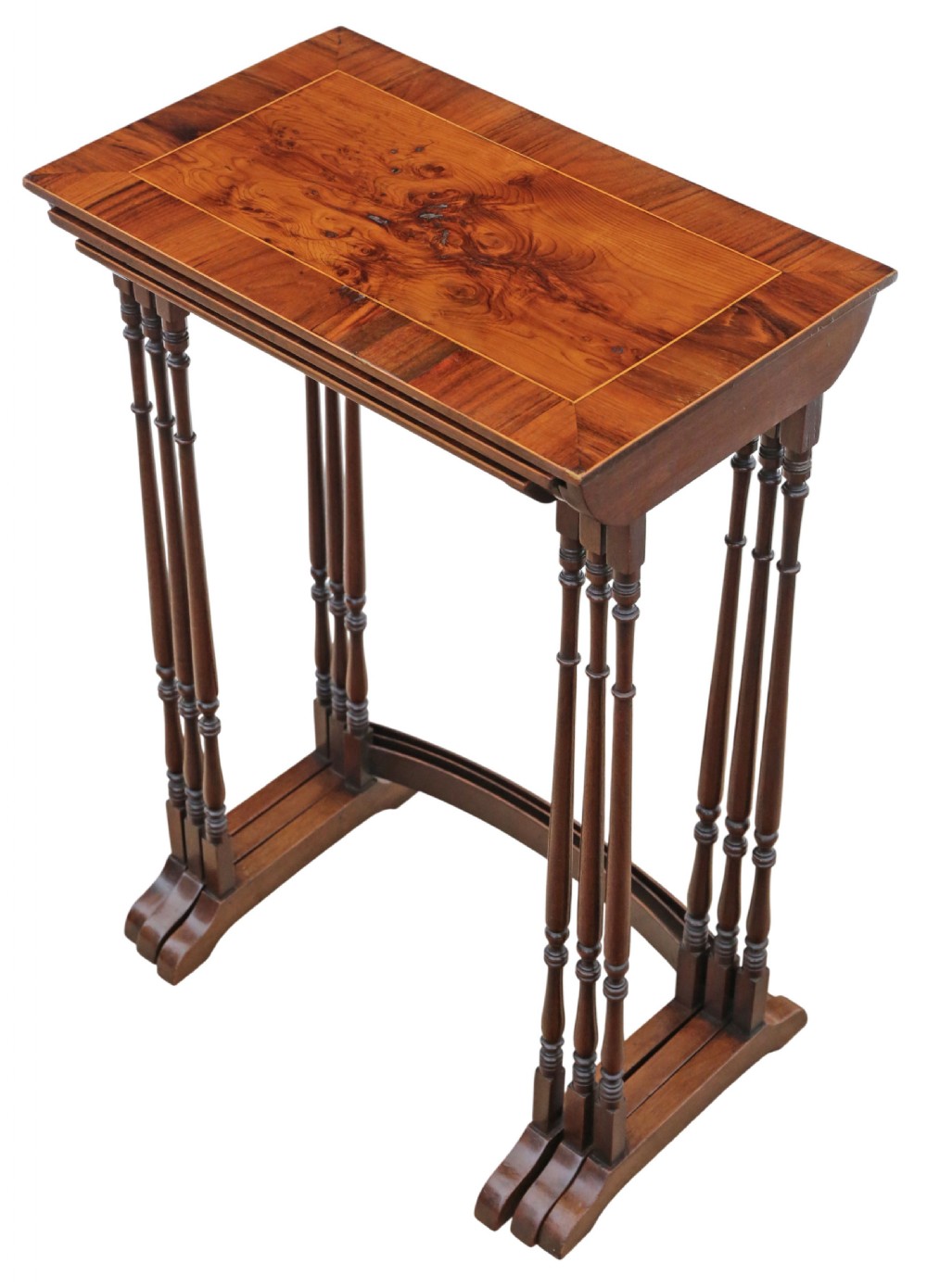 A set of three nested mahogany occasional tables featuring burr yew veneer tops with light wood inlay and slender turned legs. View II