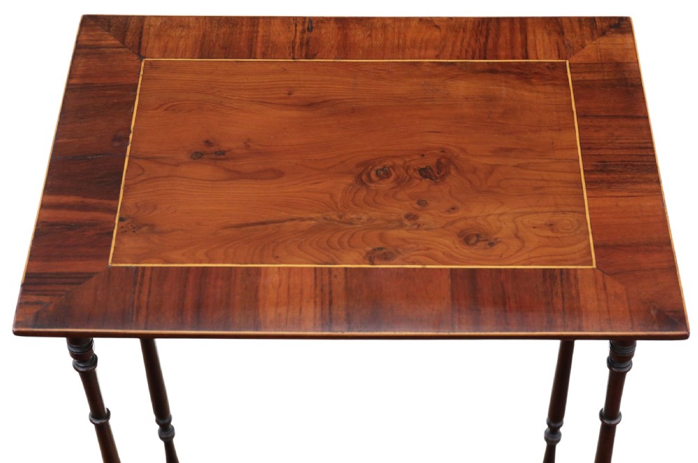 A set of three nested mahogany occasional tables featuring burr yew veneer tops with light wood inlay and slender turned legs. View IV
