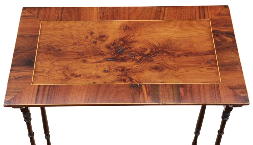 A set of three nested mahogany occasional tables featuring burr yew veneer tops with light wood inlay and slender turned legs. View VI