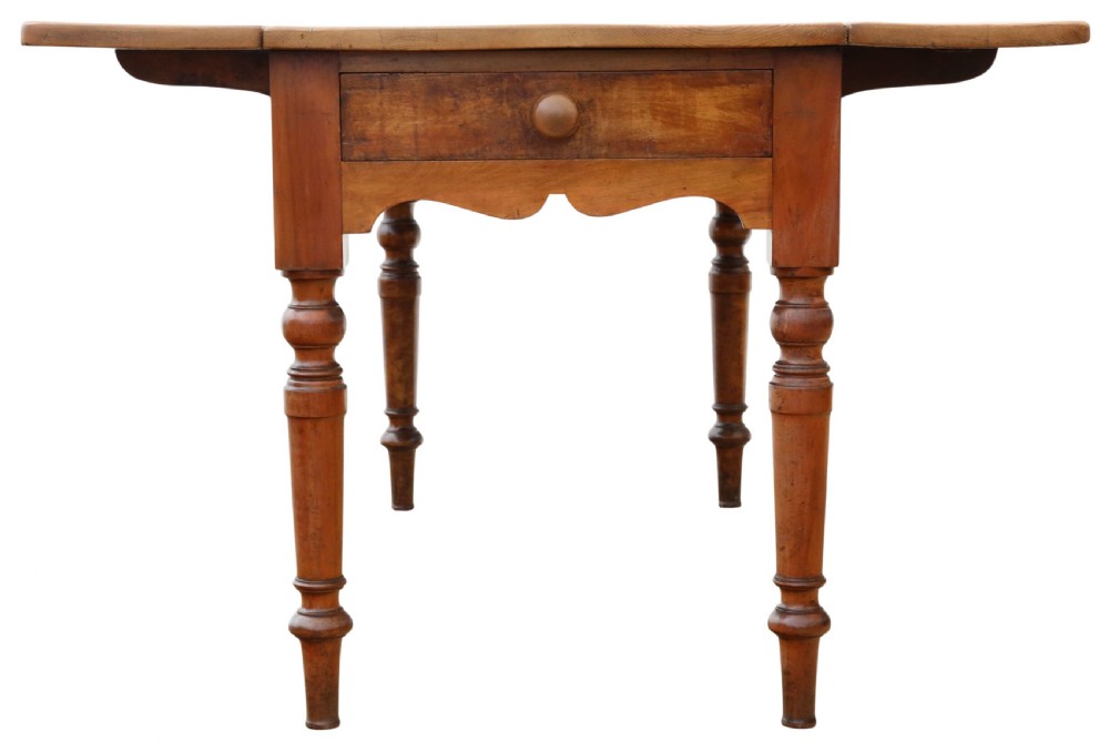 A 19th-century Victorian pine drop-leaf kitchen table featuring turned fruitwood legs, a single end drawer with a wooden knob, and a warm natural finish. View VII