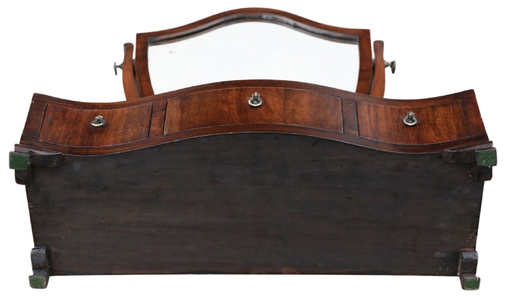 A 19th-century mahogany dressing table mirror featuring an arched shield-shaped glass frame supported by curved uprights above a serpentine base with three small drawers. View VII