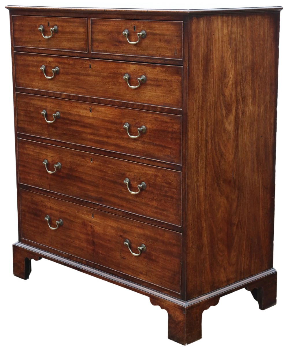 A late 18th-century Georgian mahogany chest of drawers featuring two short over three long graduated drawers with brass handles and bracket feet.