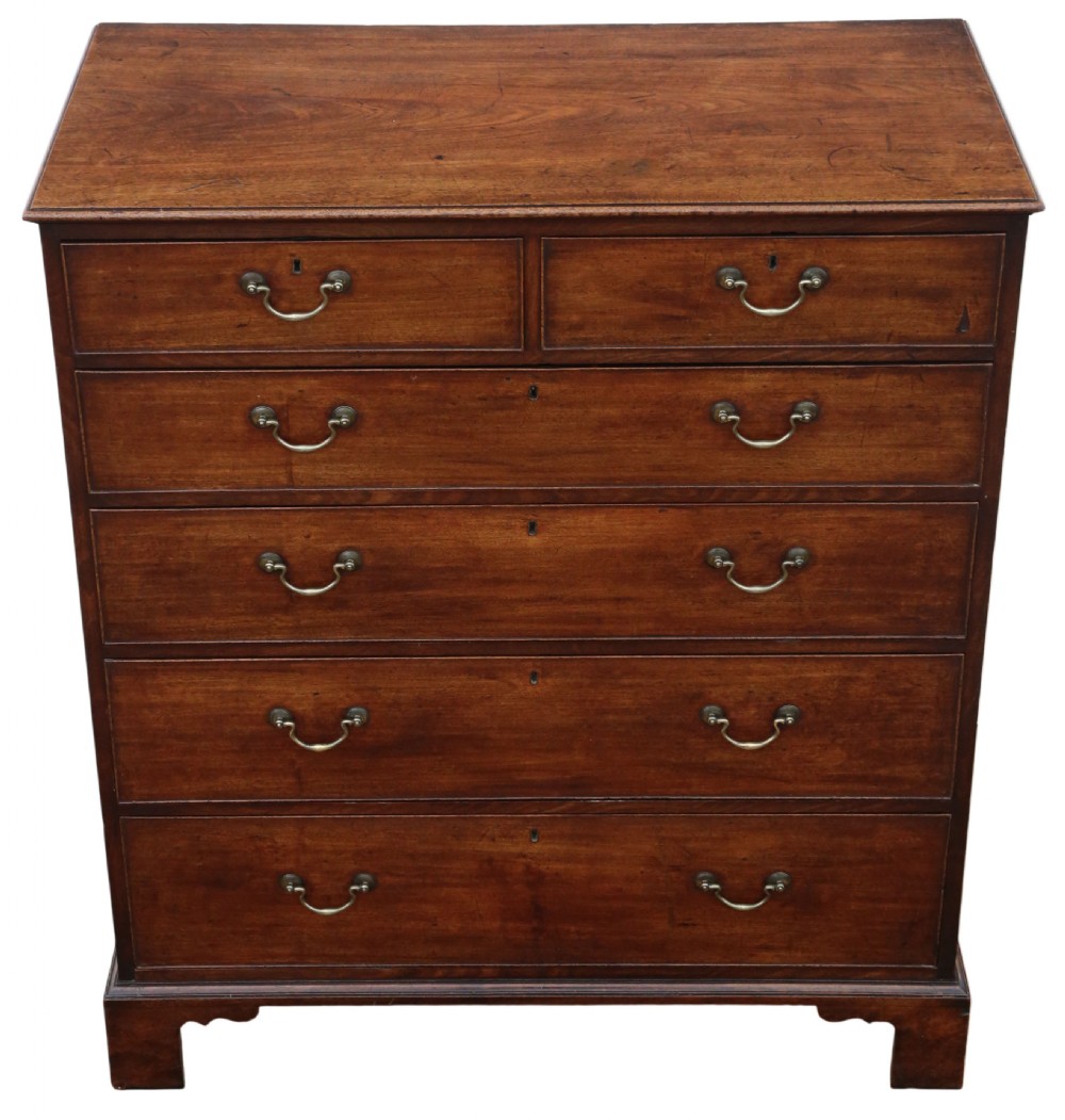 A late 18th-century Georgian mahogany chest of drawers featuring two short over three long graduated drawers with brass handles and bracket feet. View IV