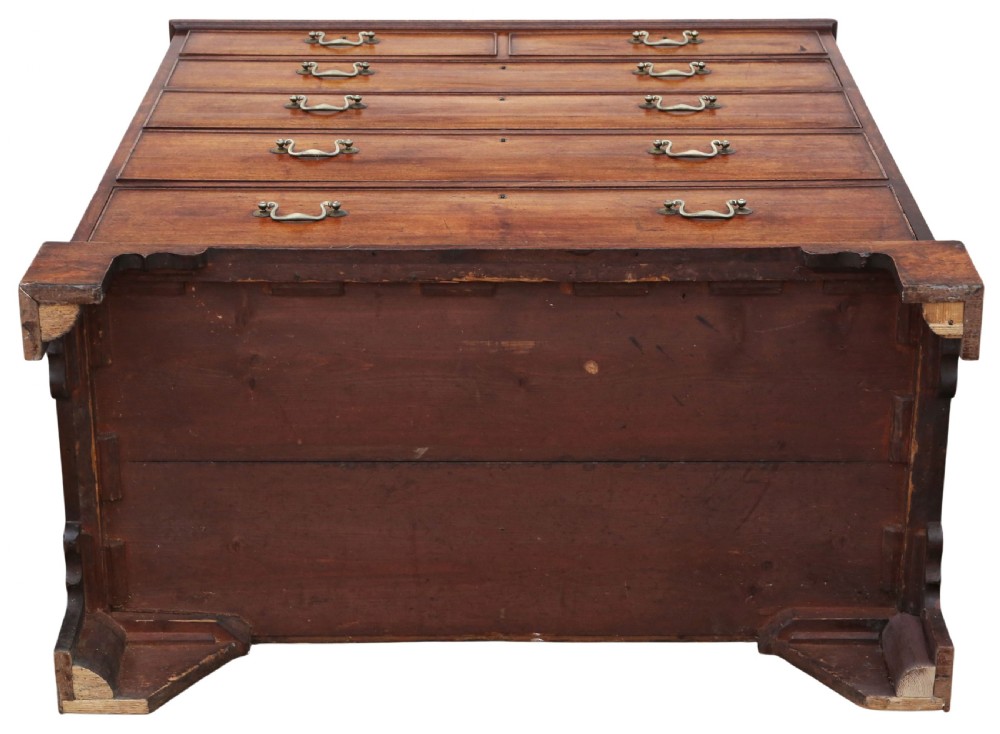 A late 18th-century Georgian mahogany chest of drawers featuring two short over three long graduated drawers with brass handles and bracket feet. View X