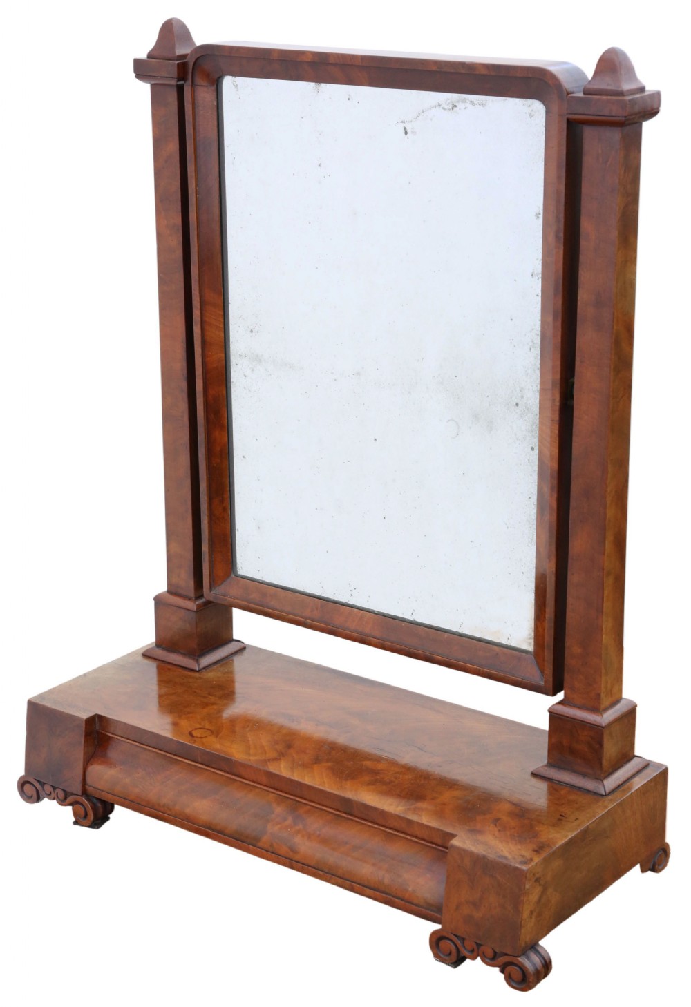 A nineteenth-century Regency mahogany dressing table mirror with a rectangular swivelling frame set between vertical posts on a plinth base with scroll feet.