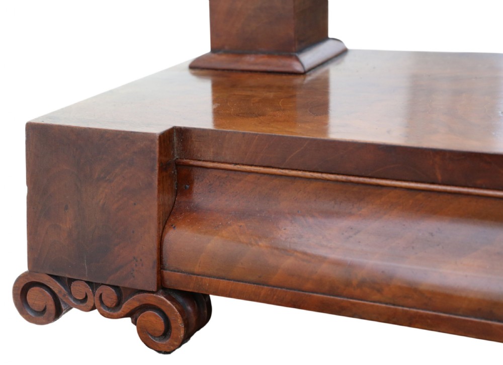 A nineteenth-century Regency mahogany dressing table mirror with a rectangular swivelling frame set between vertical posts on a plinth base with scroll feet. View III