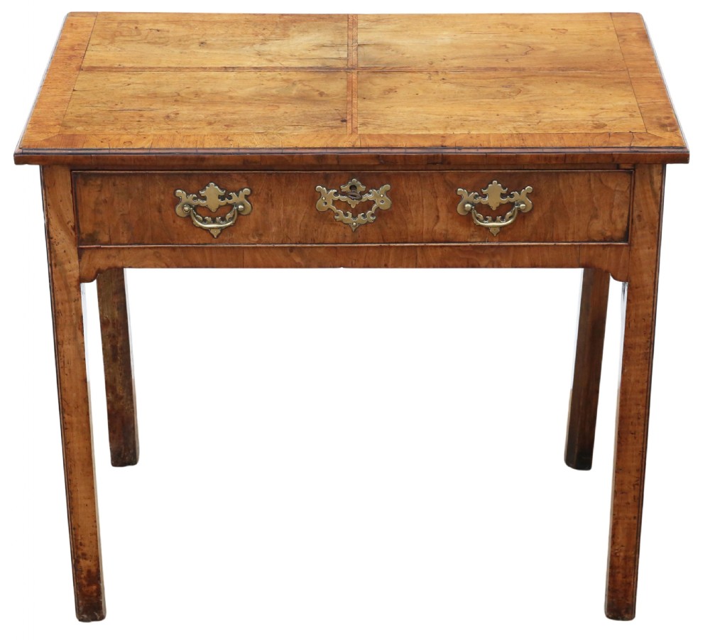An 18th-century Georgian walnut writing table featuring a quarter-veneered top, single drawer with brass drop handles, and straight square legs.