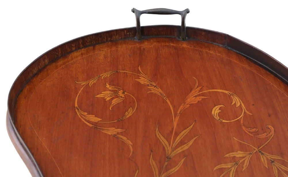 A kidney-shaped mahogany serving tray featuring floral marquetry inlay, a raised gallery, and twin brass handles. View IV