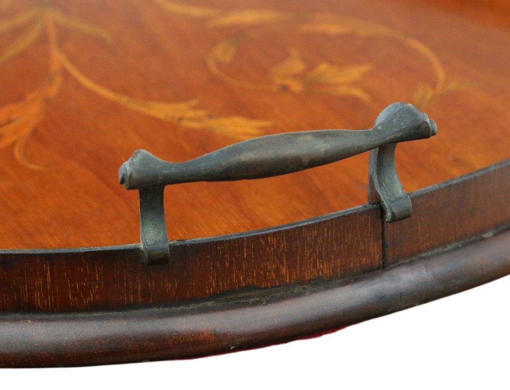 A kidney-shaped mahogany serving tray featuring floral marquetry inlay, a raised gallery, and twin brass handles. View V