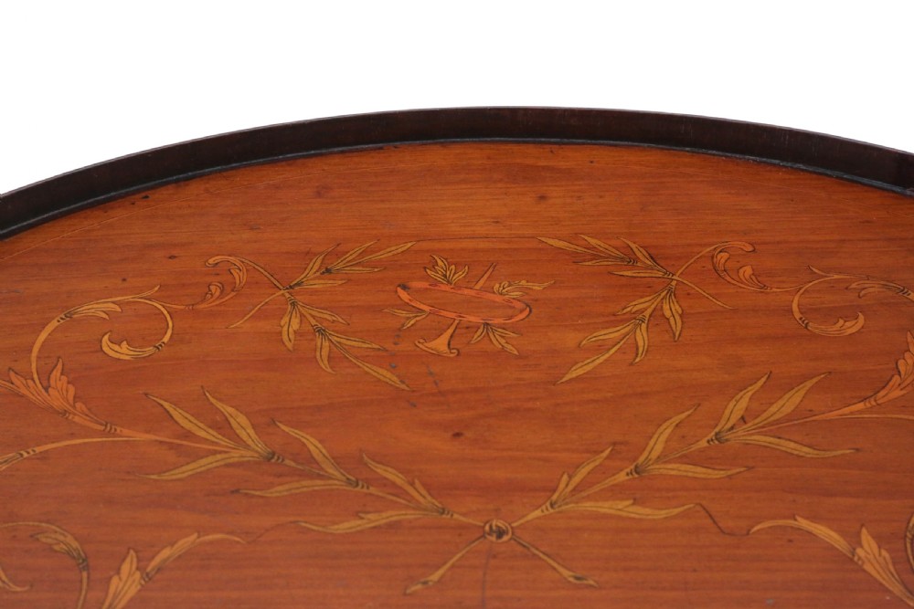 A kidney-shaped mahogany serving tray featuring floral marquetry inlay, a raised gallery, and twin brass handles. View VI