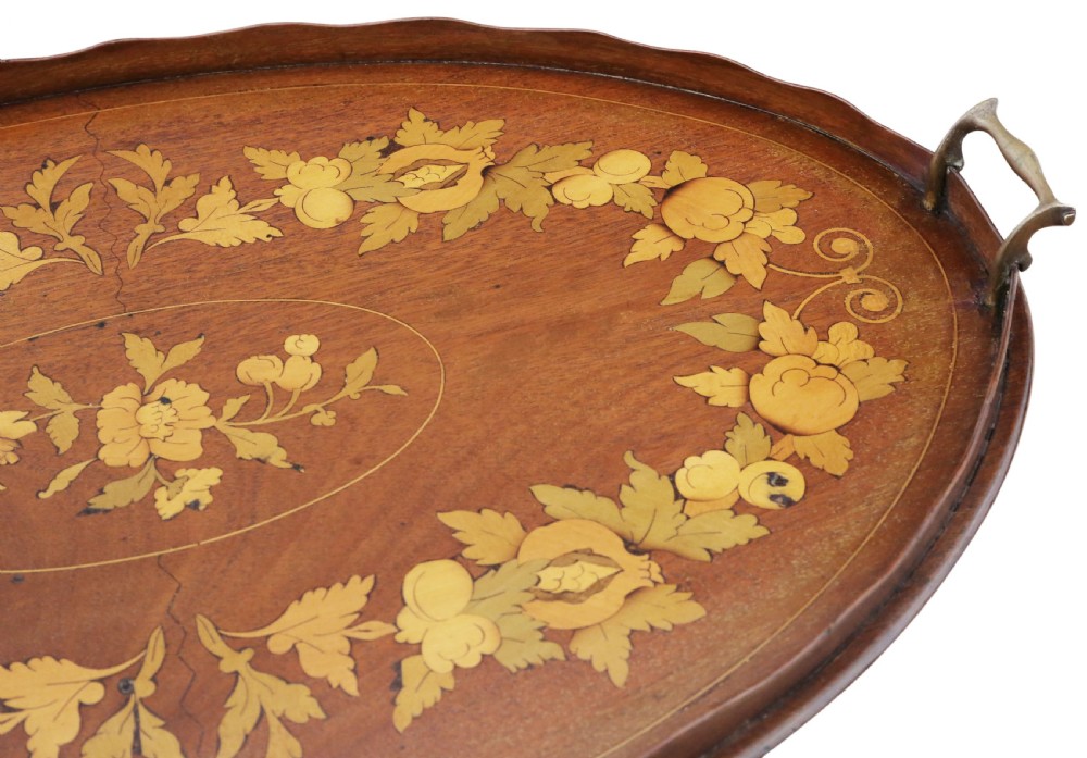 An oval mahogany serving tray featuring detailed floral marquetry inlay, a scalloped rim, and two cast brass handles. View III