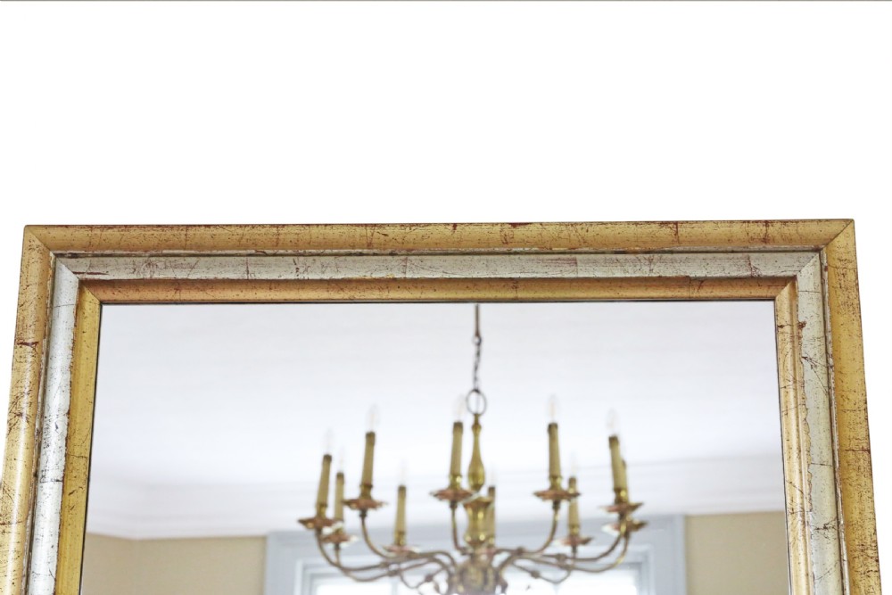 A rectangular wall mirror featuring a moulded frame with a distressed gold and silver leaf finish. View VII