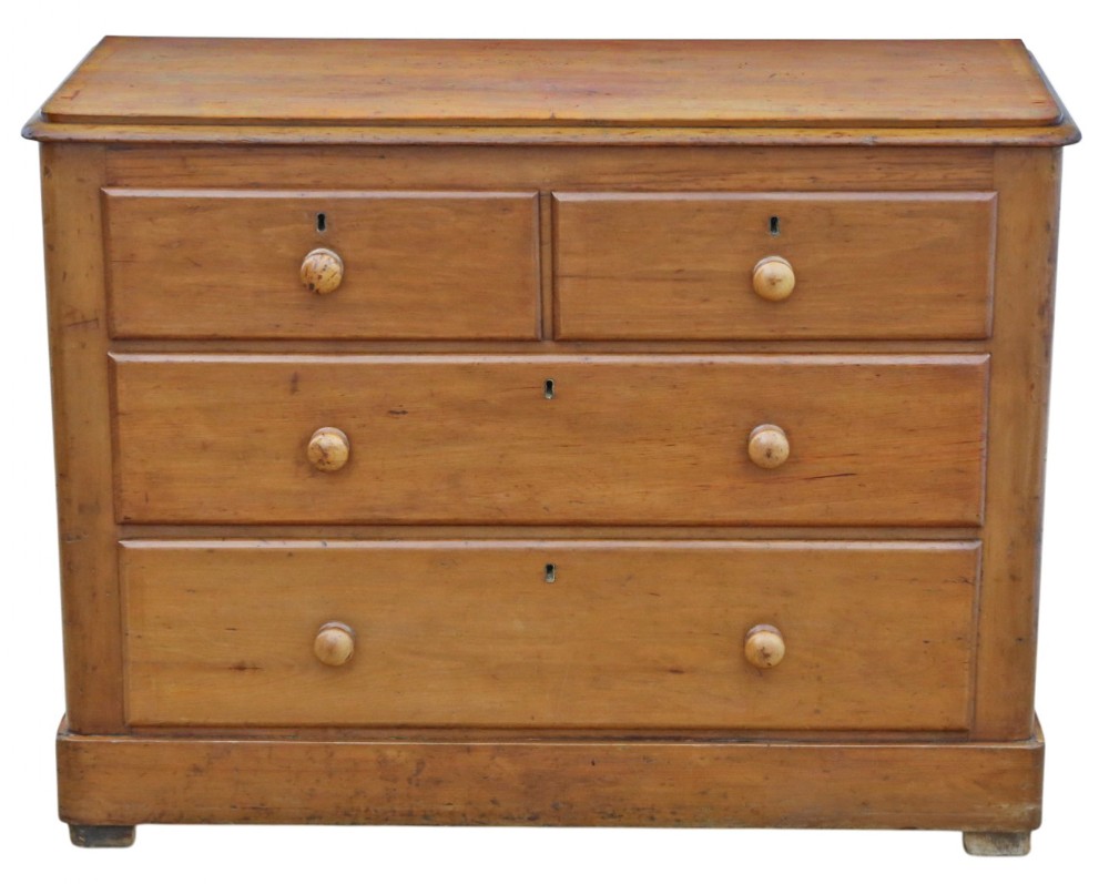Victorian pine chest of drawers featuring two short drawers over two long drawers with turned wooden knobs and keyhole escutcheons.