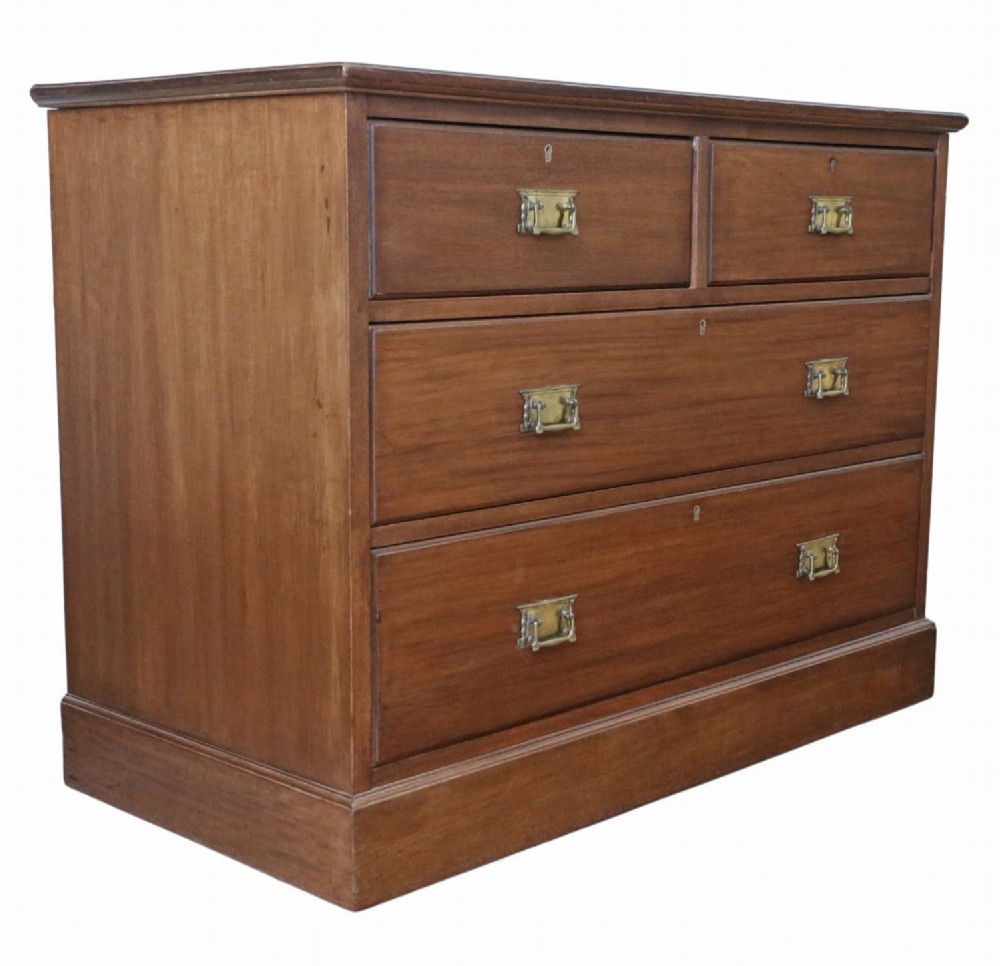 An Edwardian Art Nouveau mahogany chest of drawers featuring two short drawers above two long drawers with brass drop handles and keyhole escutcheons. View III
