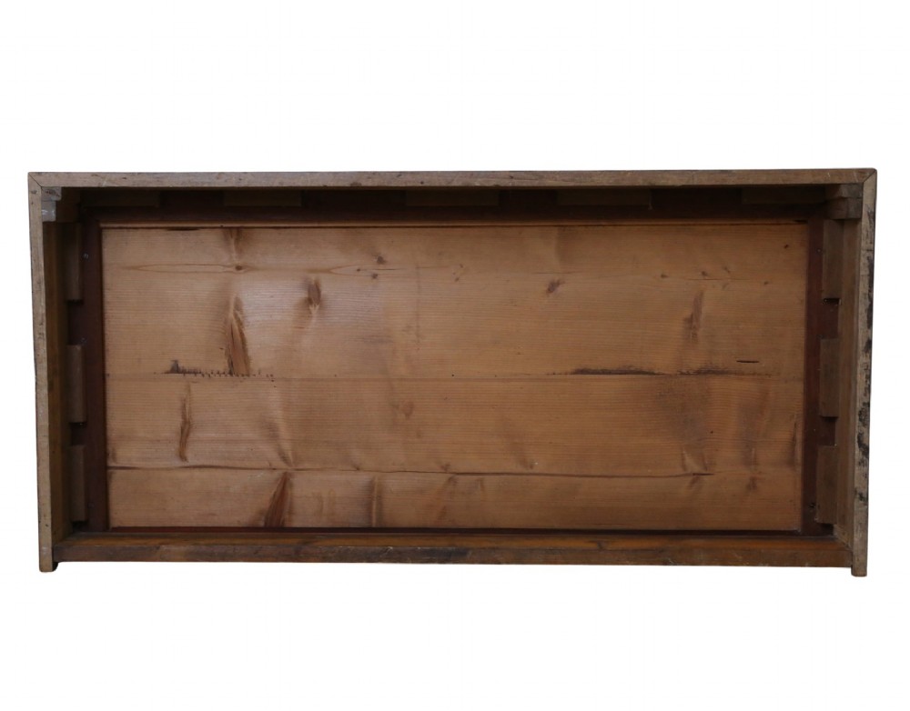 An Edwardian Art Nouveau mahogany chest of drawers featuring two short drawers above two long drawers with brass drop handles and keyhole escutcheons. View VII