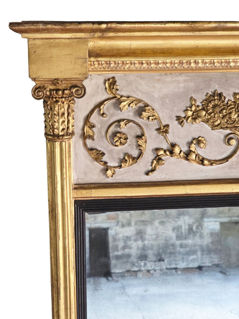 A tall 19th-century neoclassical overmantel pier mirror featuring a gilt frame, fluted side pilasters, and an upper floral frieze panel. View IV