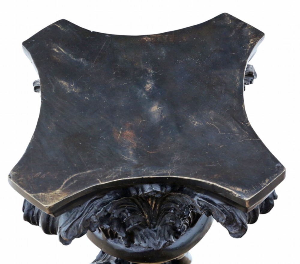 A French dark bronze and gilt pedestal stand featuring an acanthus-carved capital top, a central putto among gilded grapevines, and a stepped circular base. View IX