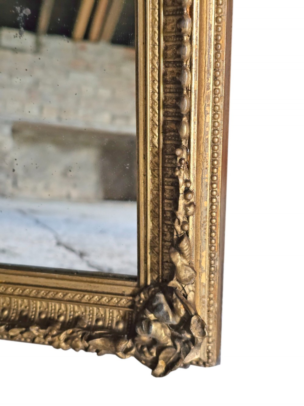 A tall rectangular full-length mirror with a gilded frame featuring delicate beaded moulding and acanthus leaf corner ornaments. View II