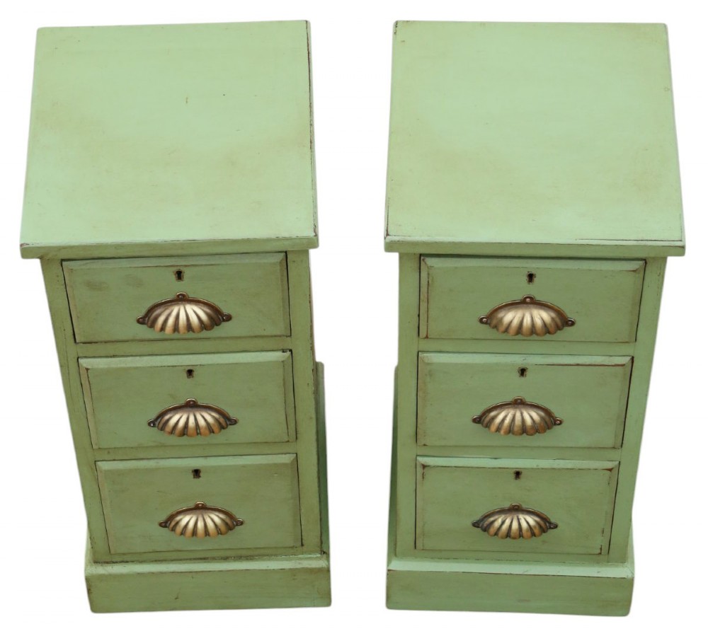 A pair of matching narrow green-painted wooden bedside cabinets, each featuring three drawers with brass shell cup handles and a solid plinth base. View III