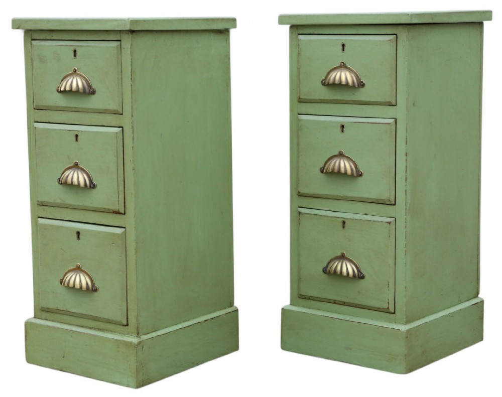 A pair of matching narrow green-painted wooden bedside cabinets, each featuring three drawers with brass shell cup handles and a solid plinth base. View V