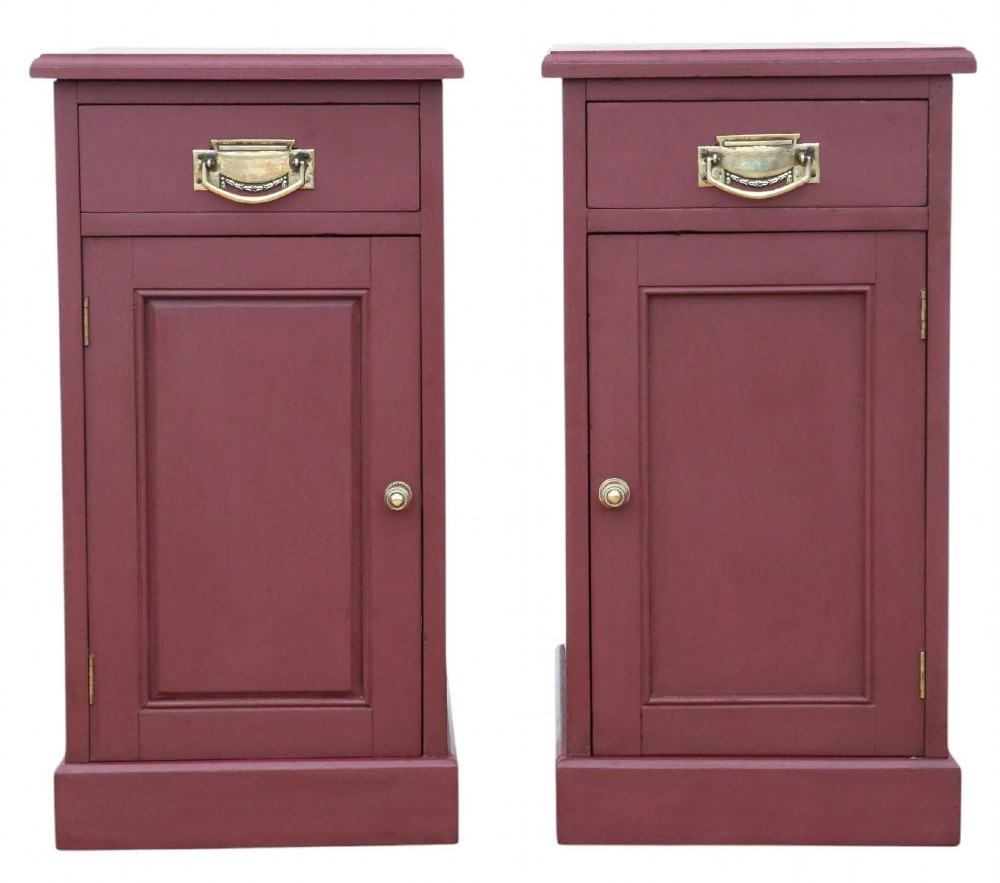 A pair of deep red painted bedside cupboards featuring top drawers with brass handles and panelled single-door cabinets below.