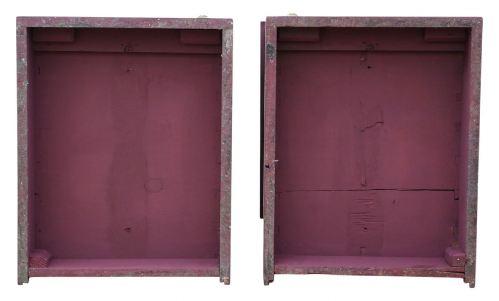 A pair of deep red painted bedside cupboards featuring top drawers with brass handles and panelled single-door cabinets below. View IX