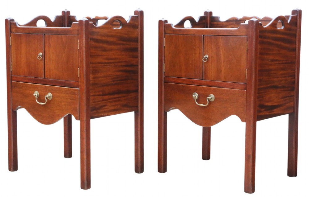 A matching pair of warm brown mahogany bedside cupboards with tray tops, double door compartments, lower drawers, and brass handles. View V