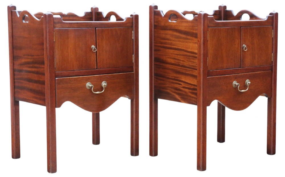 A matching pair of warm brown mahogany bedside cupboards with tray tops, double door compartments, lower drawers, and brass handles. View VI