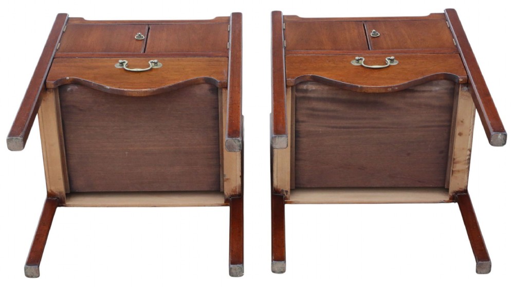 A matching pair of warm brown mahogany bedside cupboards with tray tops, double door compartments, lower drawers, and brass handles. View IX