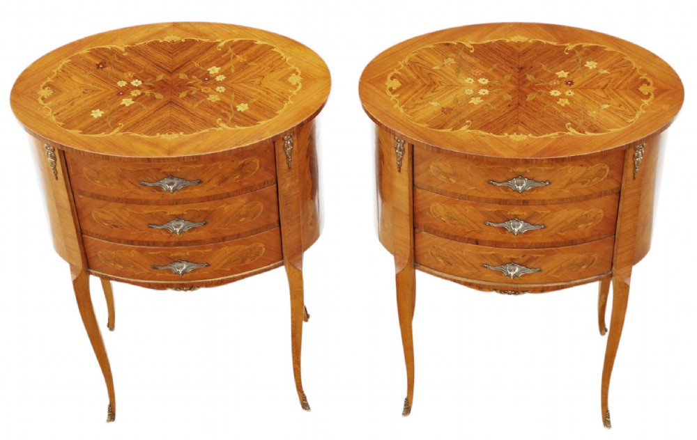 A pair of French oval bedside tables with floral marquetry inlay, three drawers, gilt mounts, and slender cabriole legs. View III