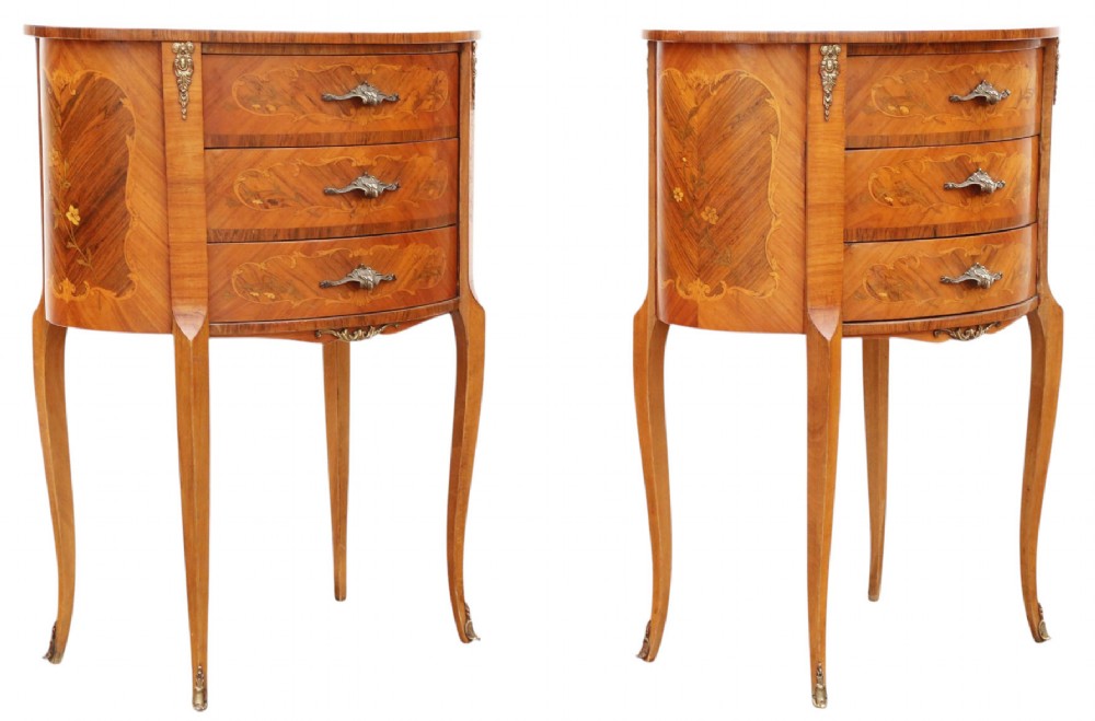 A pair of French oval bedside tables with floral marquetry inlay, three drawers, gilt mounts, and slender cabriole legs. View VIII