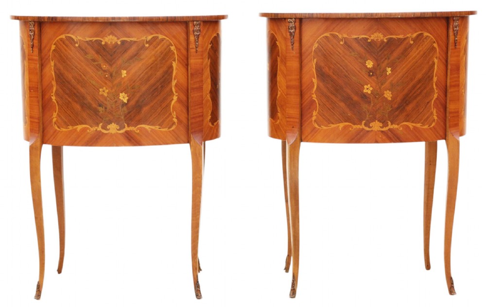 A pair of French oval bedside tables with floral marquetry inlay, three drawers, gilt mounts, and slender cabriole legs. View IX