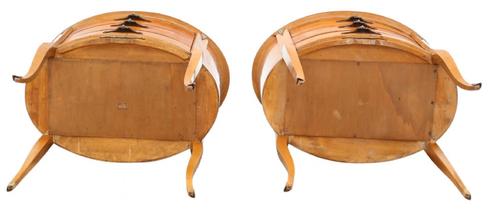 A pair of French oval bedside tables with floral marquetry inlay, three drawers, gilt mounts, and slender cabriole legs. View X