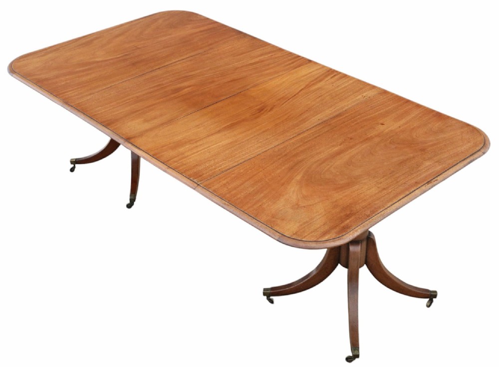 A 19th-century mahogany twin pedestal extending dining table with rounded corners, reeded edge detailing, and brass castors. View II